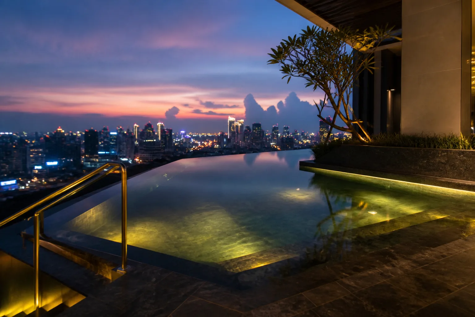 Rooftop infinity pool overlooking the city at twilight